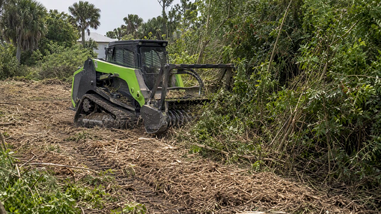 Forestry mulcher leaving vegetation chips on soil